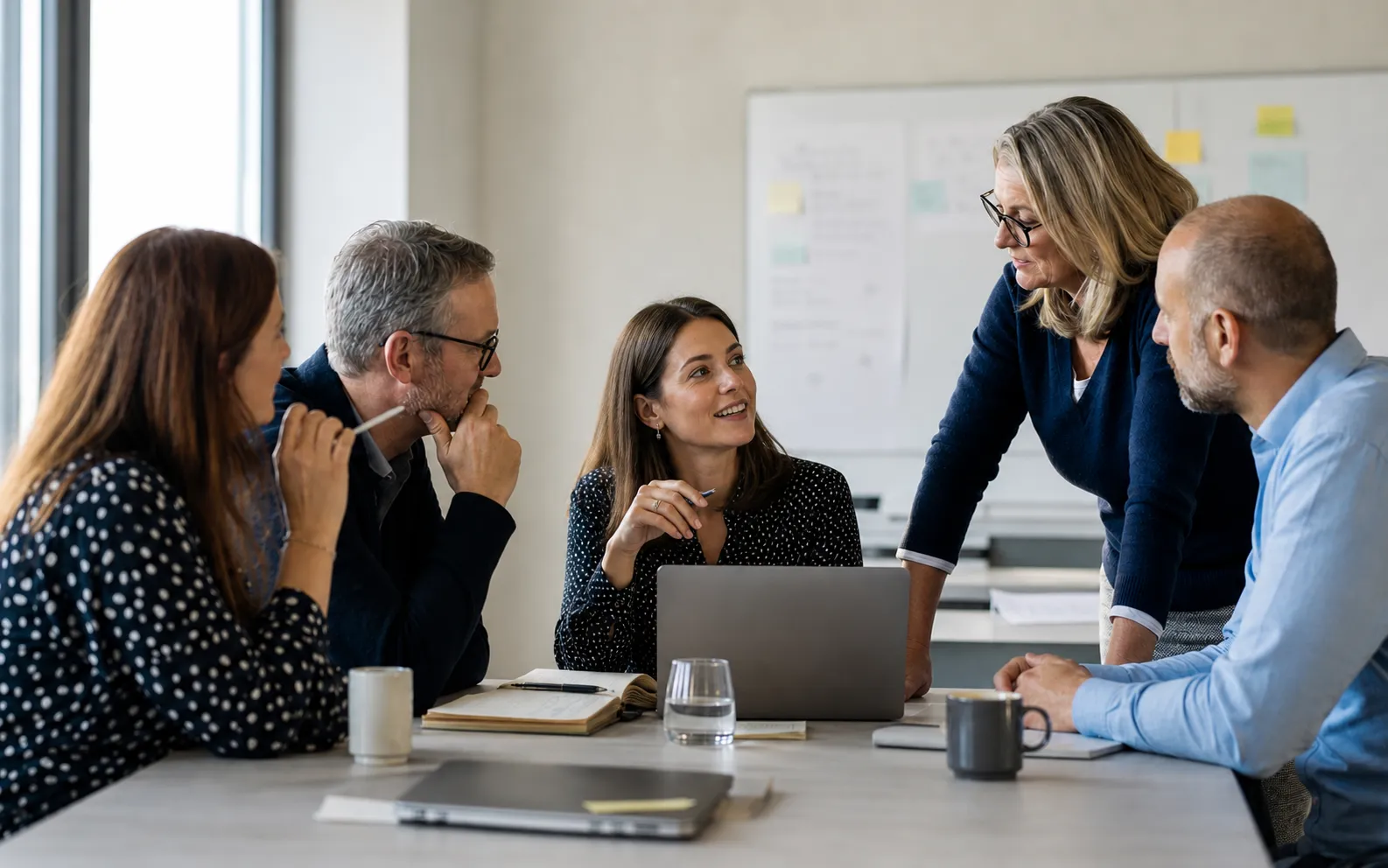 Public-sector colleagues in conversation around a meeting table